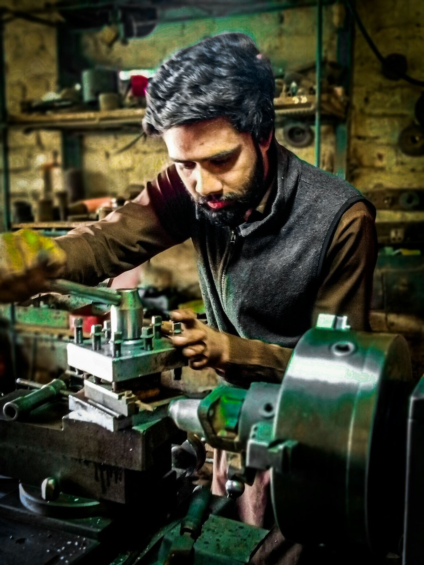 Young machinist working on a lathe