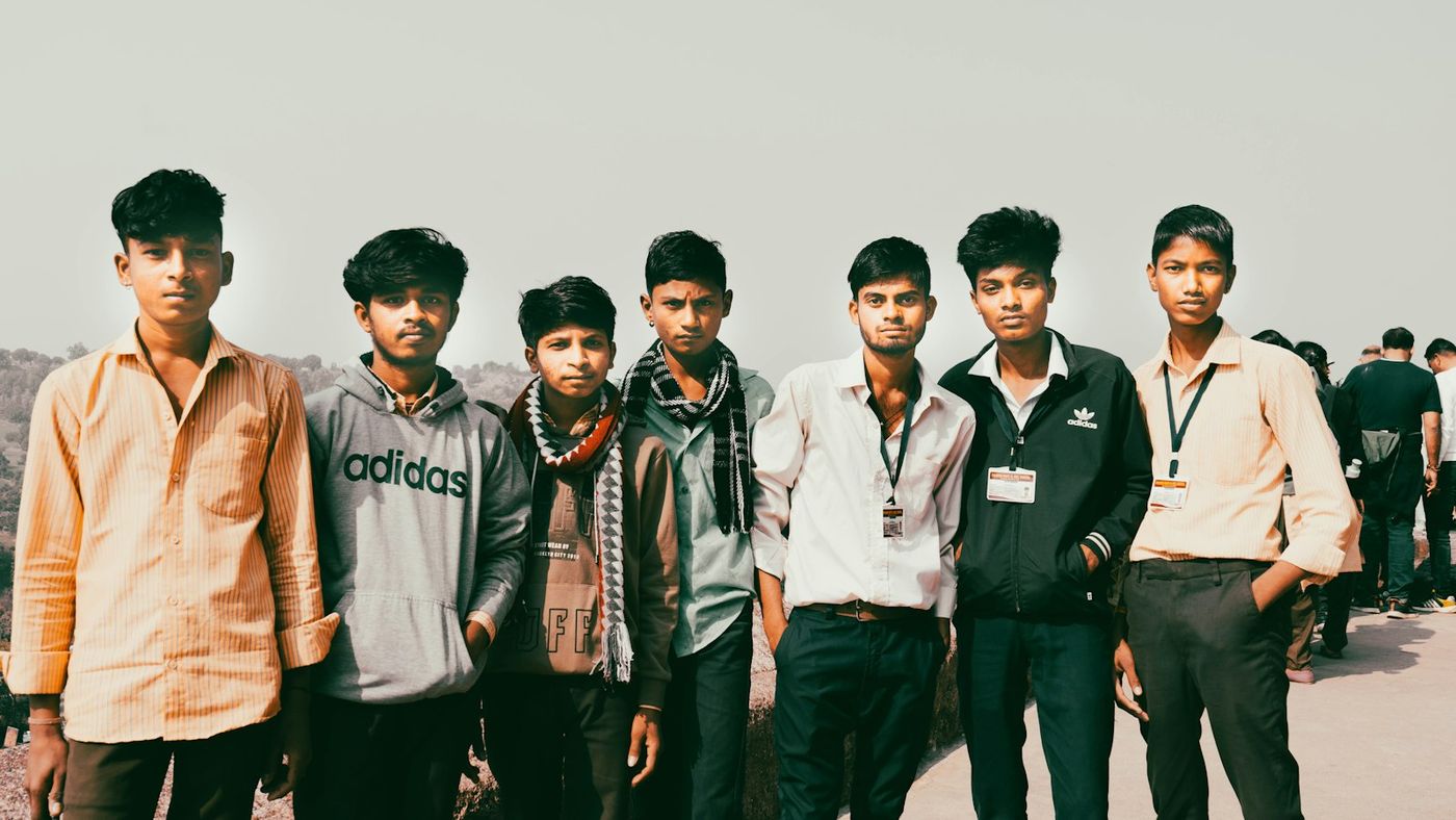 Group of young men from a village wearing ID cards