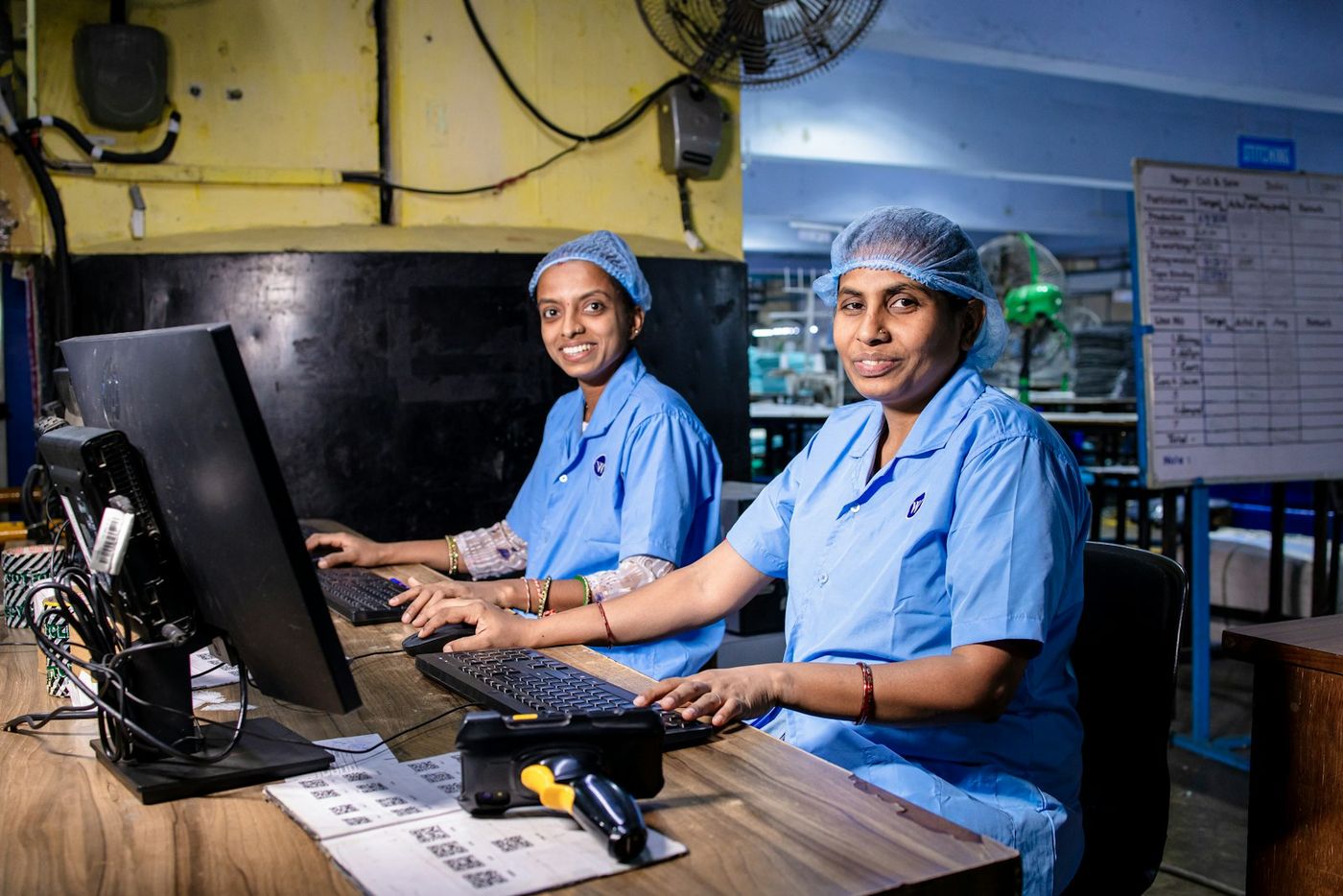 Women working on computers on a factory floor